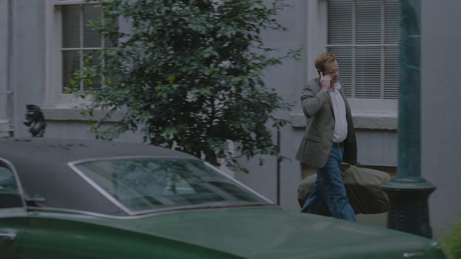 Detective Connors talks on the phone while walking back to his car.
