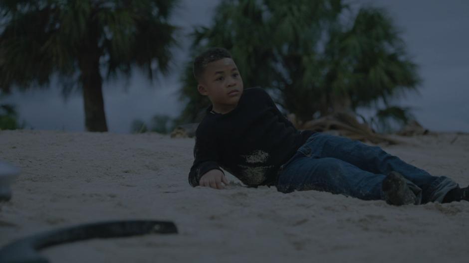 Young Tyrone wakes up alone on the beach and looks around.