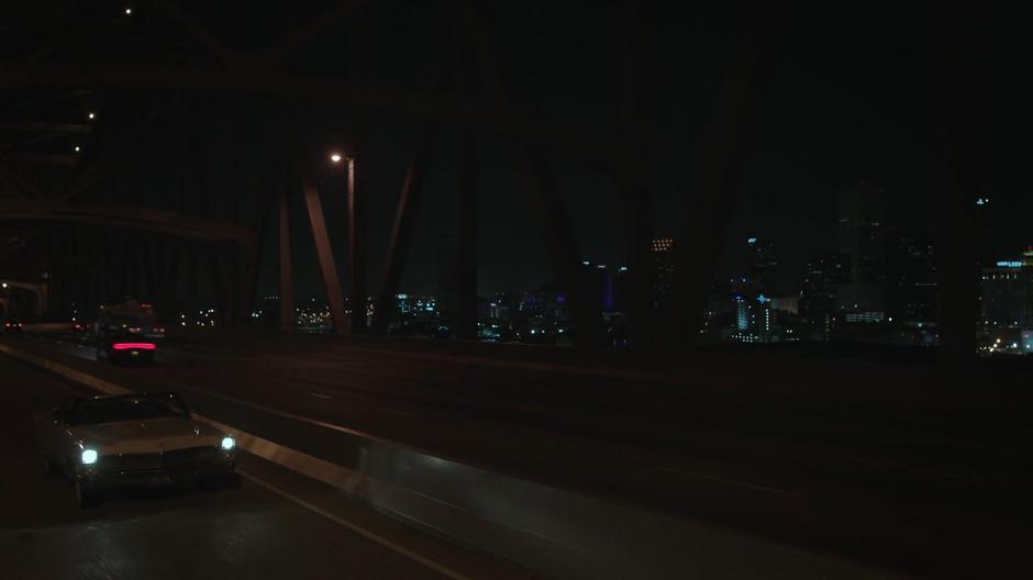 Tandy drives across the bridge away from downtown.