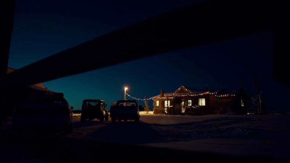 Establishing shot of the homstead srung with Christmas lights.