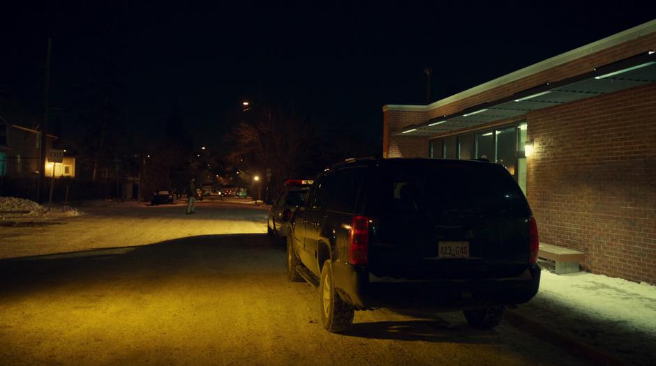 Establishing shot of Dolls' SUV sitting in front of the sheriff's office at night.