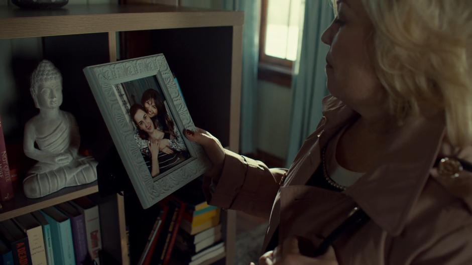 Bunny looks at a cute photo of Nicole and Waverly.