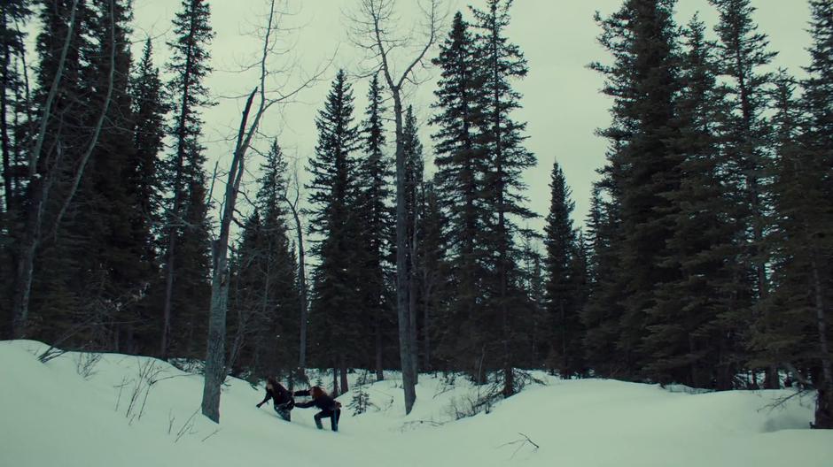 Wynonna and Nicole struggle through a ditch in the deep snow.