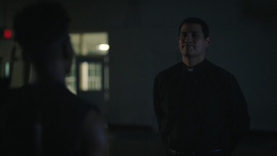 Father Delgado talks to Tyrone in the gym at night.