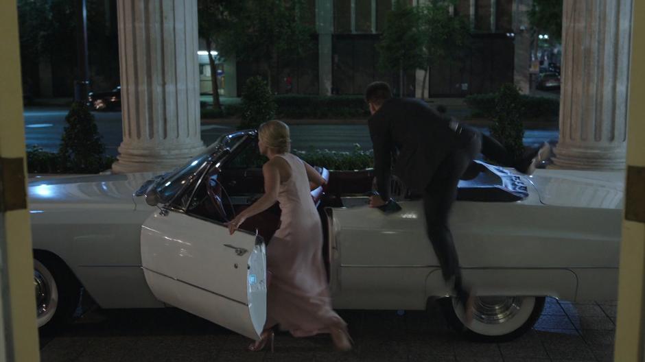 Tandy and Liam hop into the bride & groom's car.