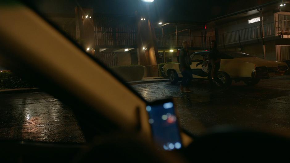 The camera propped up on Lawanda's dashboard records the two gang members carrying away her body.