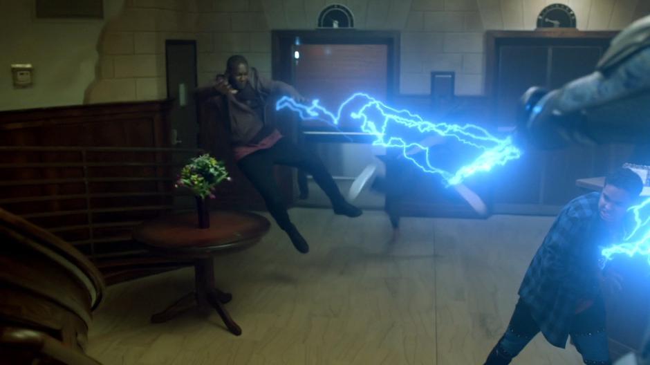 Jefferson shocks two of the guards with his lightning.