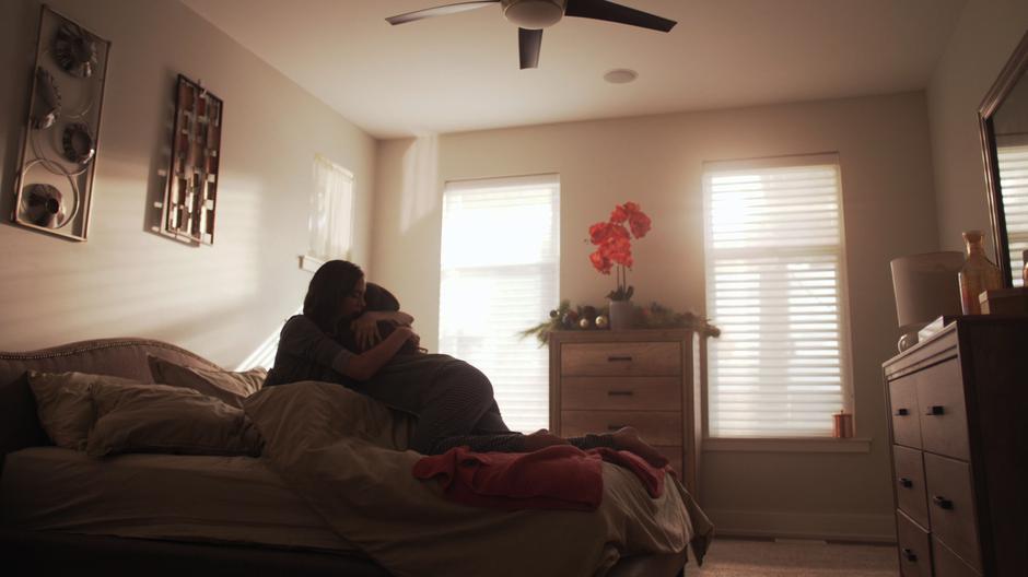 Ruby climbs into Sam's bed and hugs her.