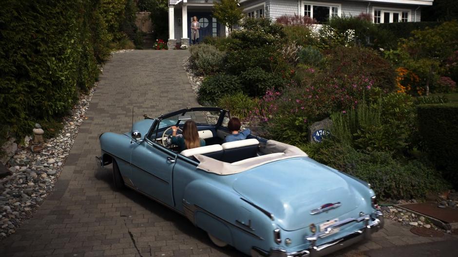 Kara pulls the car with Alex into the driveway of their home where Eliza is waiting.