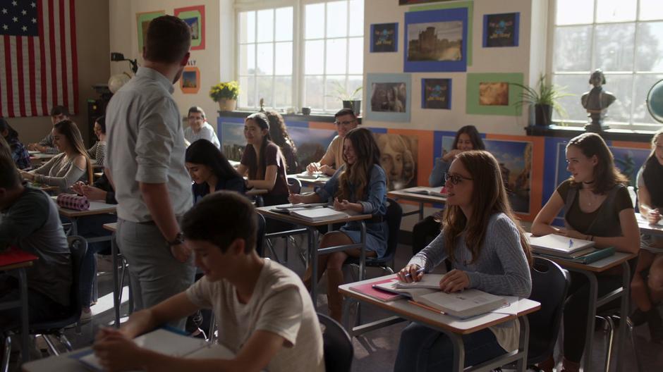 Kara and Alex listen to their teacher in class.