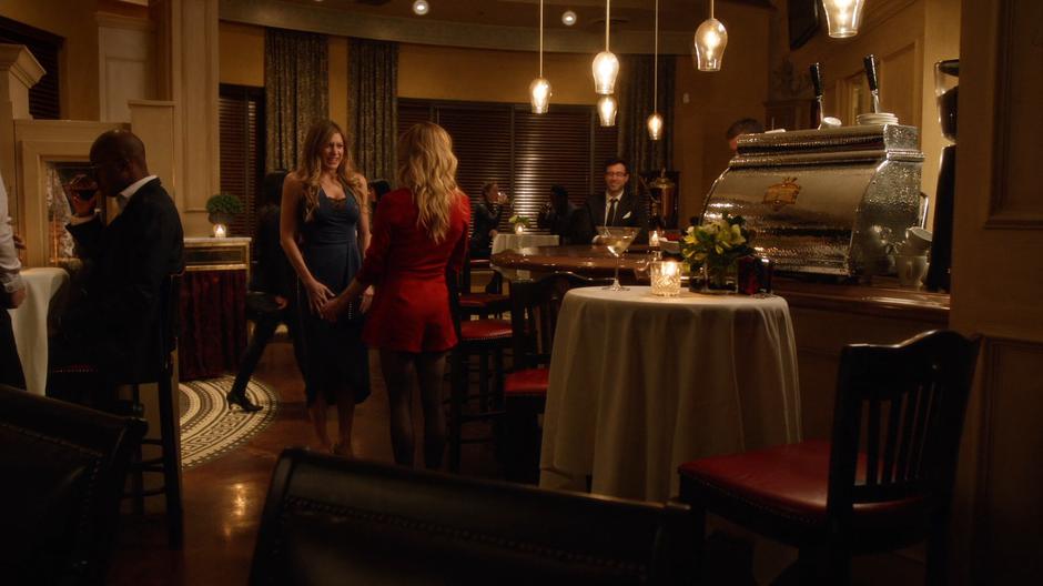 Sara stands up to greet Ava for their date.