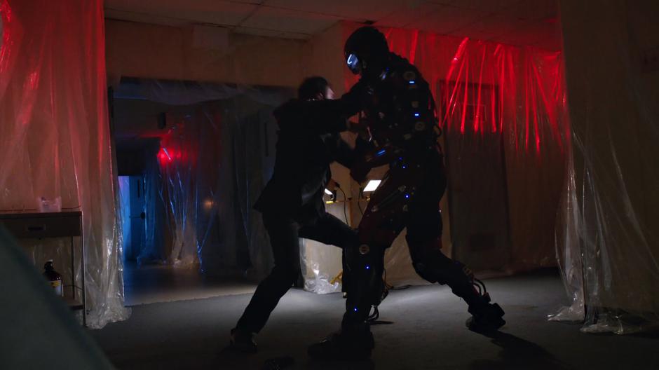 Ray fights off one of the agents to save his younger self.