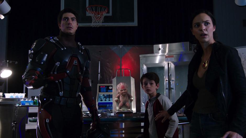Ray, his younger self, and Zari turn around from the baby alien as the agents burst into the room.