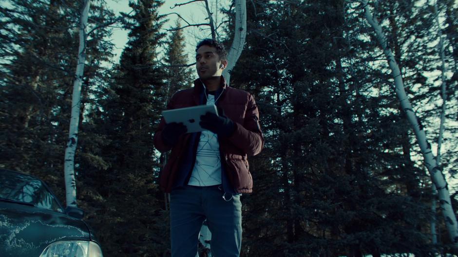Jeremy talks to Waverly on the phone while standing by his car.