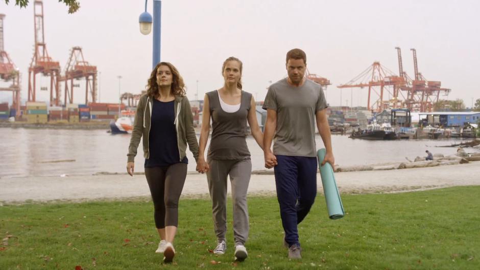 Izzy, Emma, and Jack walk up to the birthing class holding hands.