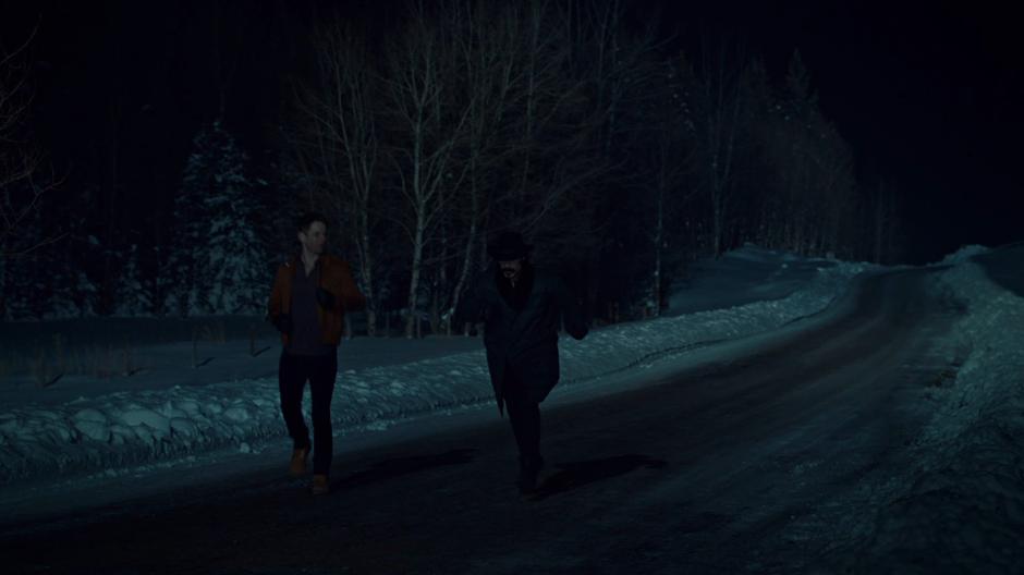 Charlie and Doc jog down the snowy road in the dark.