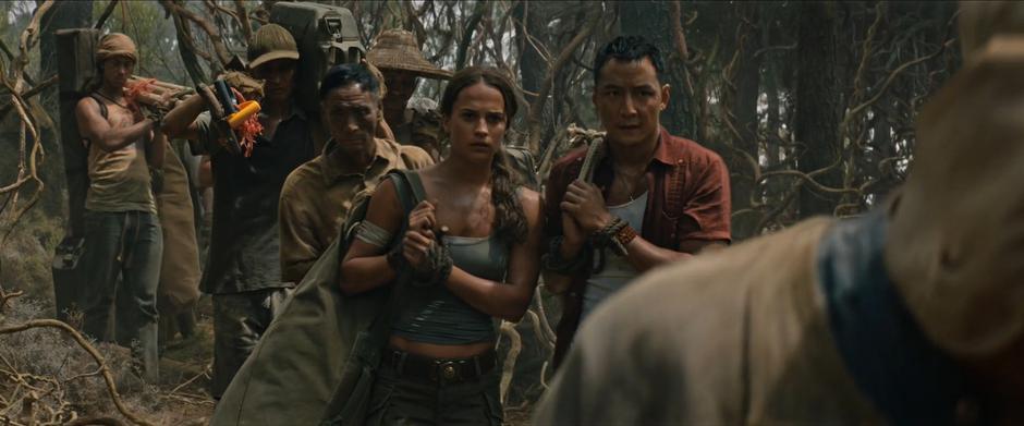 Lara talks with Lu Ren as they are marched through the jungle to the new dig site.