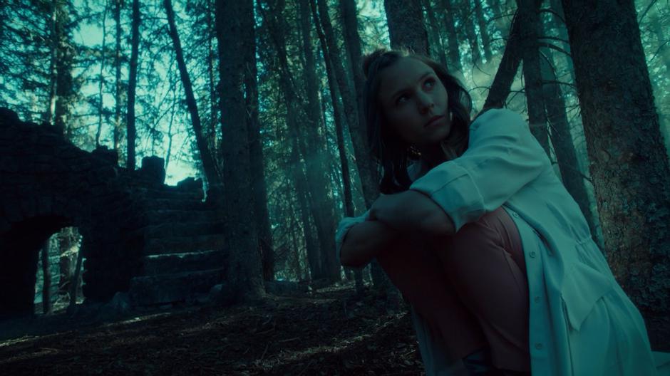 Waverly looks up at Wynonna from where she is kneeling by the foot of the stairs.
