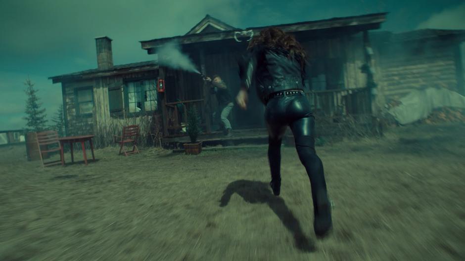 Wynonna runs to the front of the house while a Revenant fires at Bulshar's goons.