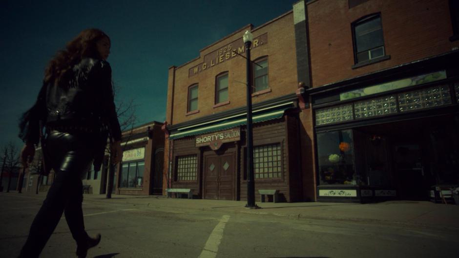 Wynonna walks across the empty street over to the saloon.