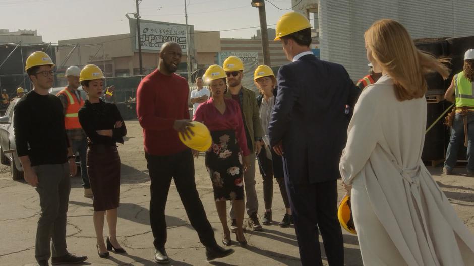 Geoffrey calls out Jonah while the rest of the parents stand around in hard hats.