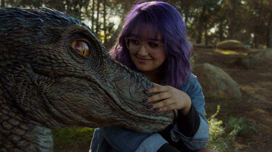Gert rubs her dino's snout while saying goodbye.