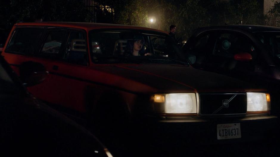 Gert pulls the car to a stop in the parking lot outside the party.