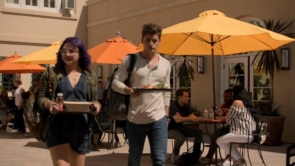 Gert and Chase walk together with their trays of food during lunch.
