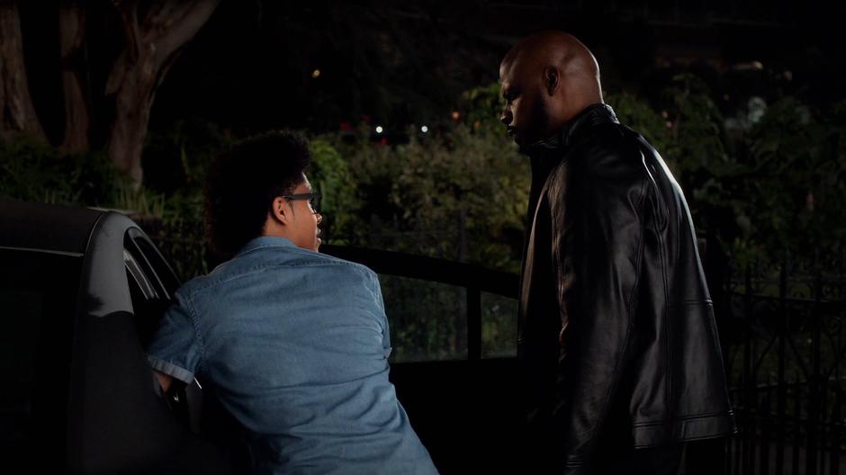 Alex turns to his father after checking on Andre in the back seat.