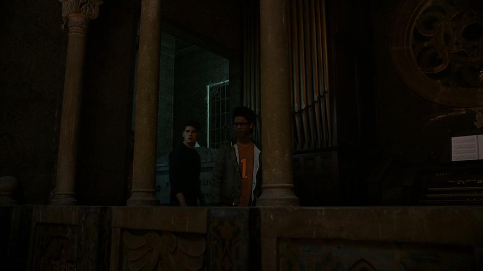 Alex and Chase walk into the upper balcony of the temple.