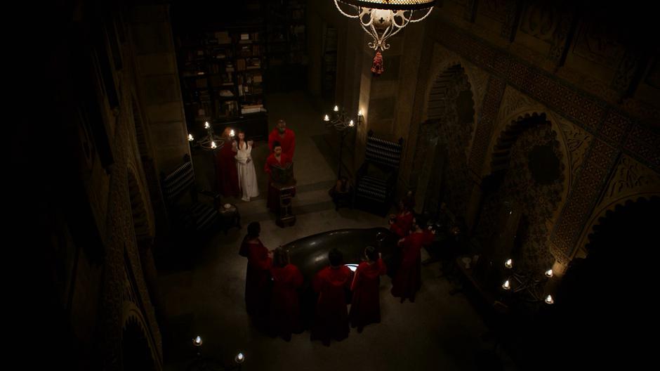 Leslie leads Destiny into the temple while the other members of the PRIDE stand around in their red robes.