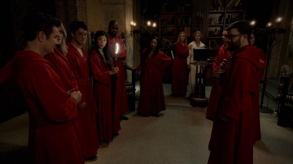Leslie leads in the first sacrifice as the others stand around in their new red robes.