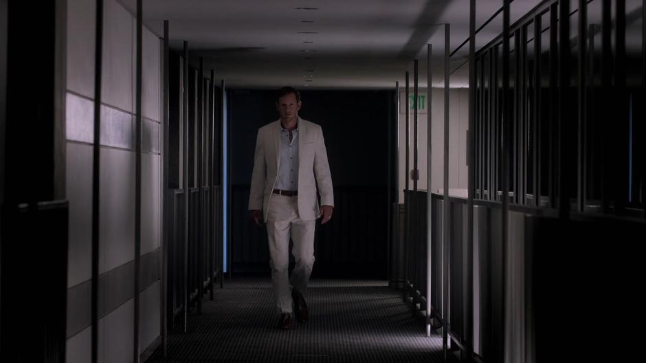 Frank walks through the darkened offices.