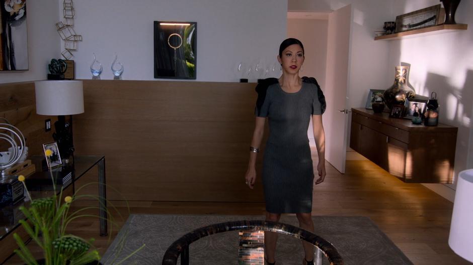 Tina enters her office and stops while trying to decide what to do.
