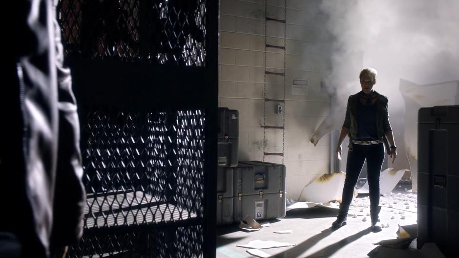 Vanessa Jansen walks into the warehouse through the destroyed door.
