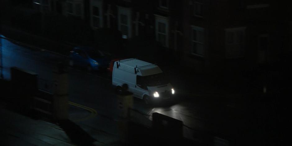 Rahul's van drives down the road at night.