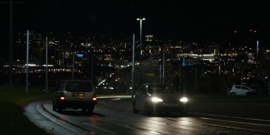 The gang drives down the road towards town.