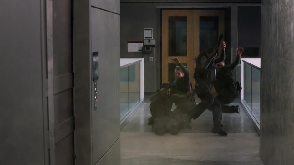 Four goons are thrown back by Kara's breath.