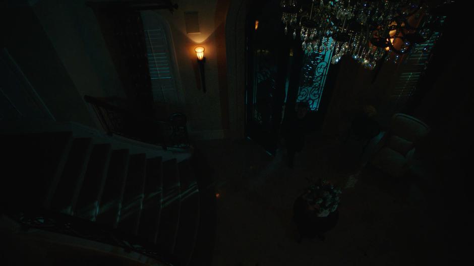 Nate and Mick walk into the dark mansion through the front door.