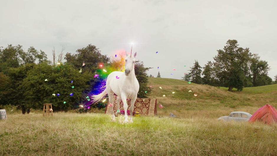 The unicorn gallops across the field leaving a trail of rainbow light and butterflies.