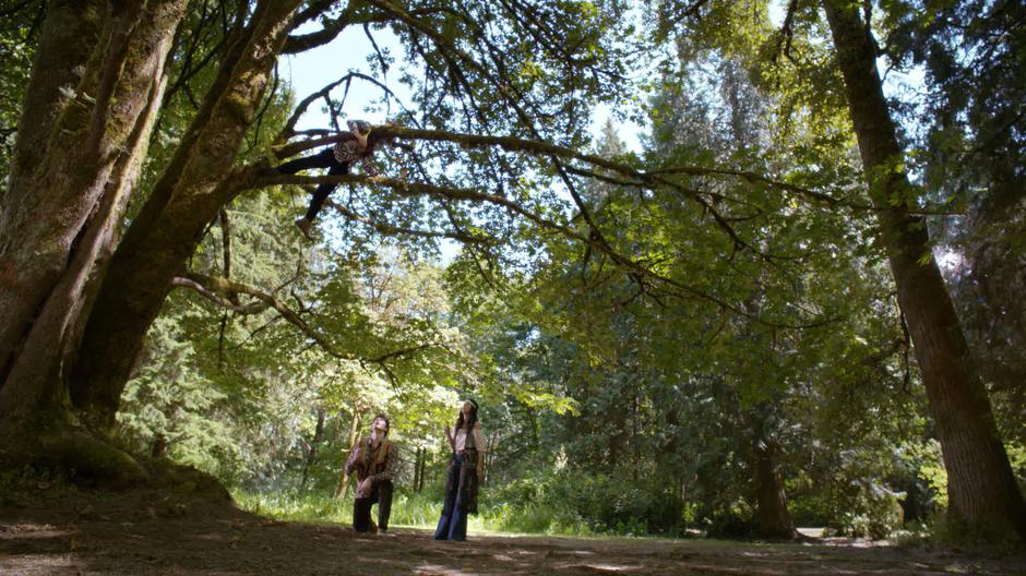 Ray and Zari look up at the heartless body in the tree.