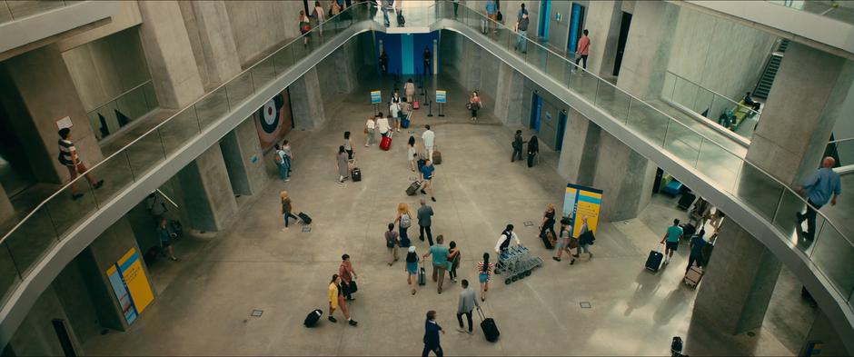 Kitty, Margo, Lara Jean, and their father walk into the airport departure area.