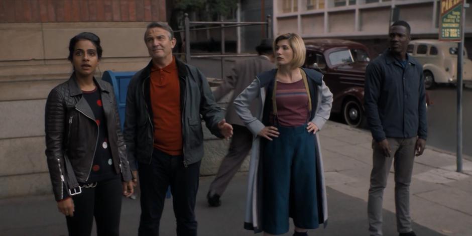 Yasmin, Graham, the Doctor, and Ryan look over at Rosa Parks' workplace.