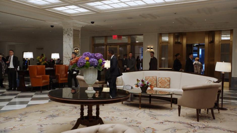 Victor and Roman enter the hotel lobby.