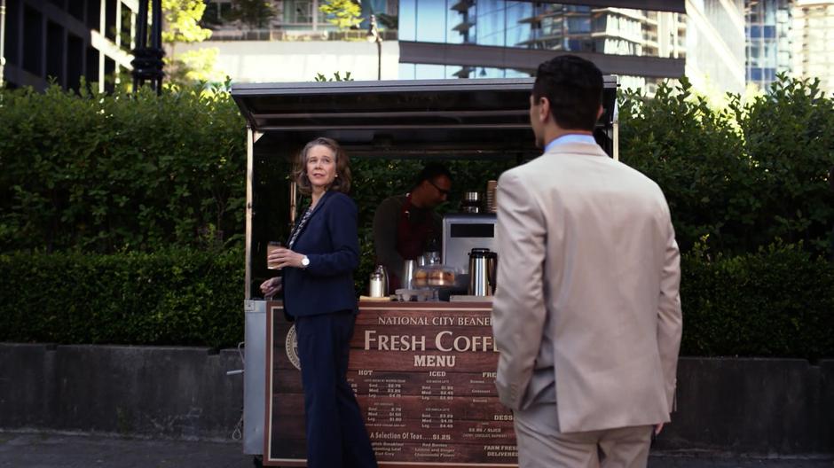 Dean Warren turns around as Ben Lockwood approaches her at the coffee stand.