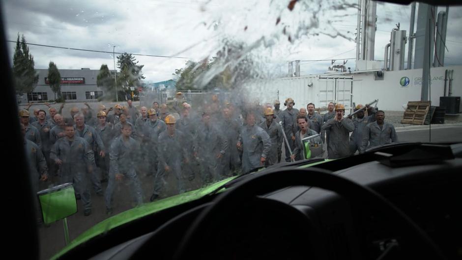 The employees of Lockwood Family Steel throw things at the delivery truck.