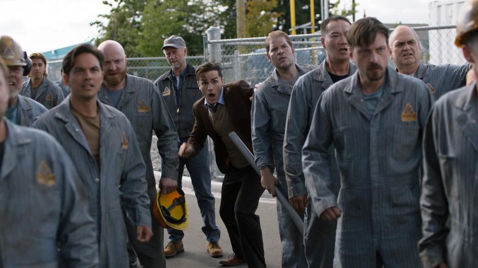 Peter Lockwood watches as Ben runs through the crowd to protect the truck driver.