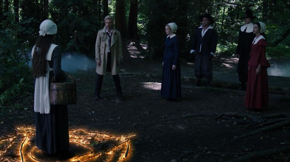 Sara, Mick, Ray, and Zari watch as Constantine summons the demon forth.