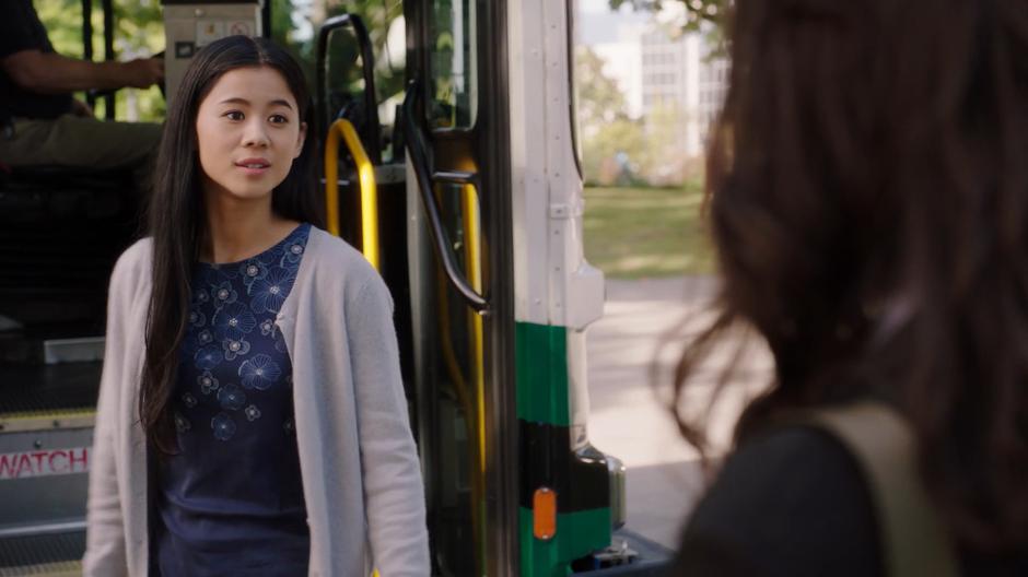Angela Wu turns away from the bus as Mel gets her attention.