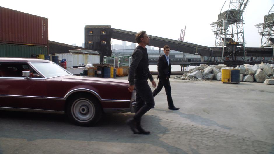 Sherloque and Ralph walk onto the docks from their car.